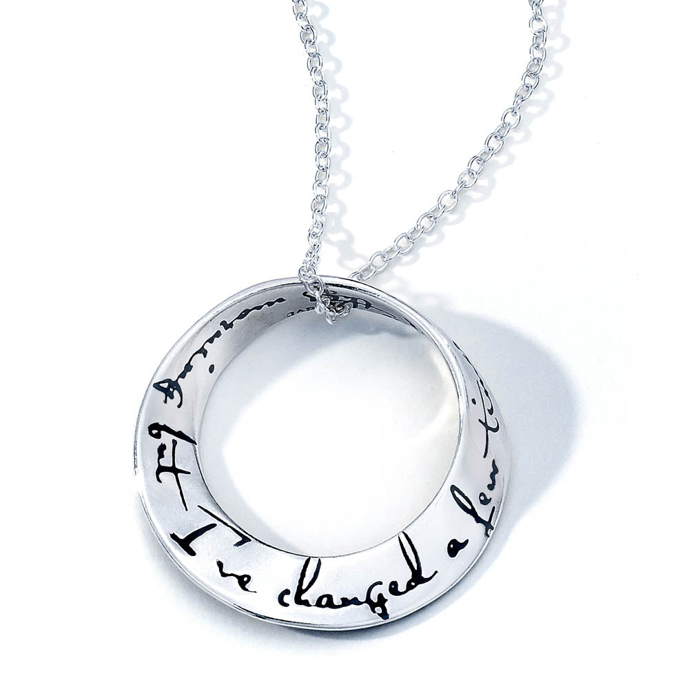 white gold round pendant with quote inscribed