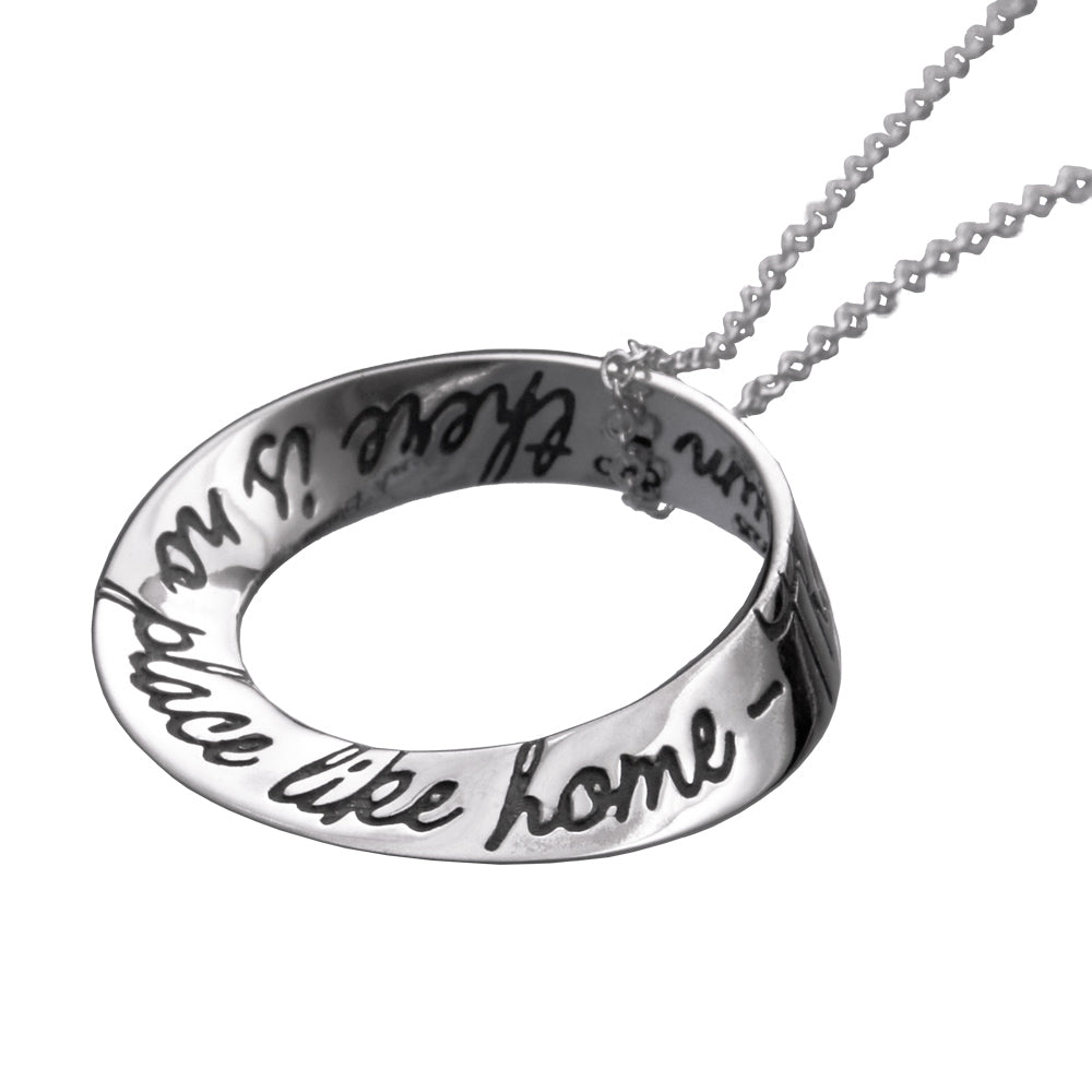 white gold round pendant with wizard of oz quote inscribed